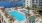 N/A	Downtown Jacksonville, FL Apartments For Rent - The Strand - Resort-Style Pool with Spacious Sundeck, Lounge Seats, Spa Under a Pergola, BBQ Area, Tables and Chairs, Manicured Shrubs, Palm Trees, and View of River